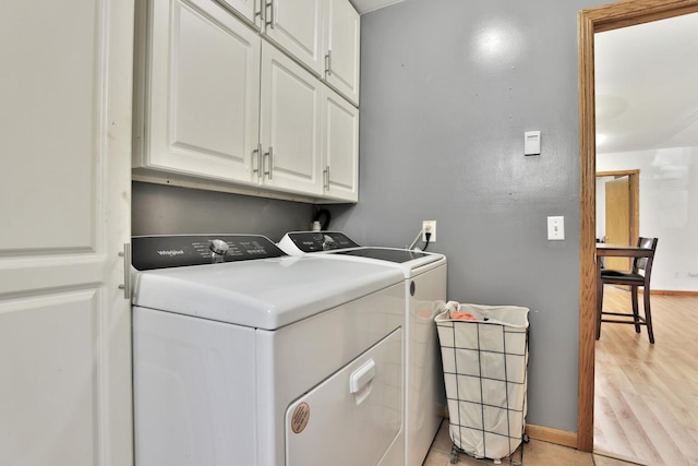 75309 Twin Oaks Rd, Bremen Twp, MN 55735 - laundry room featuring cabinet space, washer and dryer, and light wood-type flooring