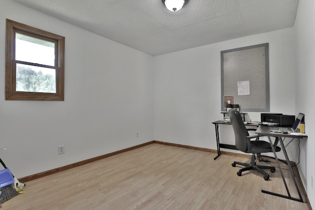 75309 Twin Oaks Rd, Bremen Twp, MN 55735 - home office featuring light wood-style floors and a textured ceiling