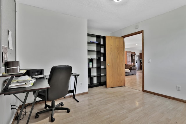 75309 Twin Oaks Rd, Bremen Twp, MN 55735 - home office with light wood-style floors and a textured ceiling