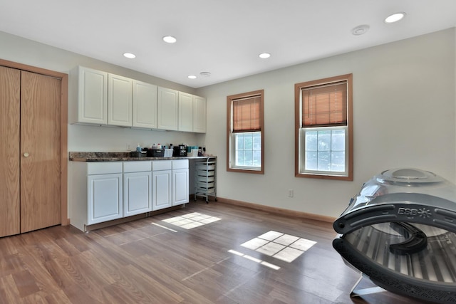 75309 Twin Oaks Rd, Bremen Twp, MN 55735 - kitchen with light wood-style floors, white cabinets, dark countertops, and recessed lighting