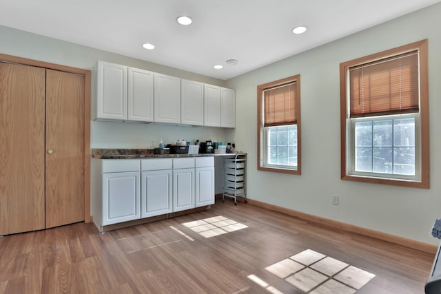 75309 Twin Oaks Rd, Bremen Twp, MN 55735 - kitchen with light wood-style floors, white cabinets, recessed lighting, and dark countertops