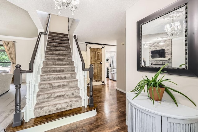791 139th Ln NW, Andover, MN 55304 - stairs featuring a chandelier, a textured ceiling, and wood finished floors