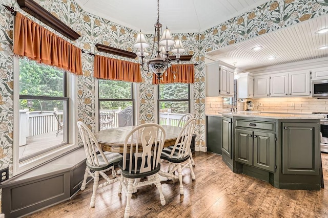 791 139th Ln NW, Andover, MN 55304 - dining space with wallpapered walls, a chandelier, light wood-type flooring, and ornamental molding