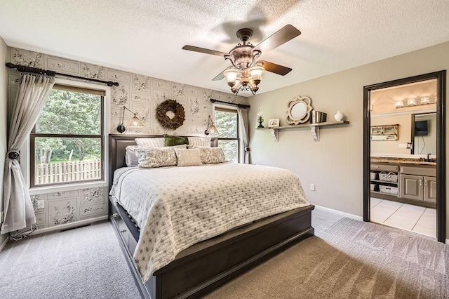 791 139th Ln NW, Andover, MN 55304 - bedroom with light colored carpet, a textured ceiling, wallpapered walls, ensuite bath, and a ceiling fan