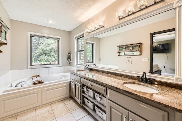 791 139th Ln NW, Andover, MN 55304 - bathroom featuring tile patterned flooring, a textured ceiling, a garden tub, and double vanity