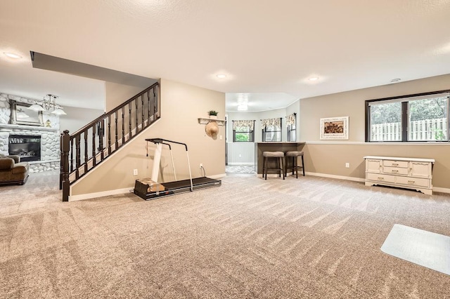 791 139th Ln NW, Andover, MN 55304 - carpeted living room with a fireplace, stairs, and recessed lighting