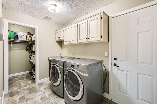 791 139th Ln NW, Andover, MN 55304 - laundry area featuring independent washer and dryer, cabinet space, and a textured ceiling