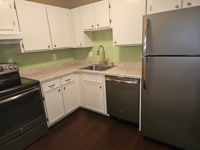 1855 Silver Bell Rd Unit 301, Eagan, MN 55122 - kitchen with appliances with stainless steel finishes, exhaust hood, dark wood-type flooring, white cabinets, and light countertops