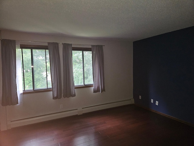 1855 Silver Bell Rd Unit 301, Eagan, MN 55122 - spare room featuring baseboard heating, dark wood-style flooring, and a textured ceiling
