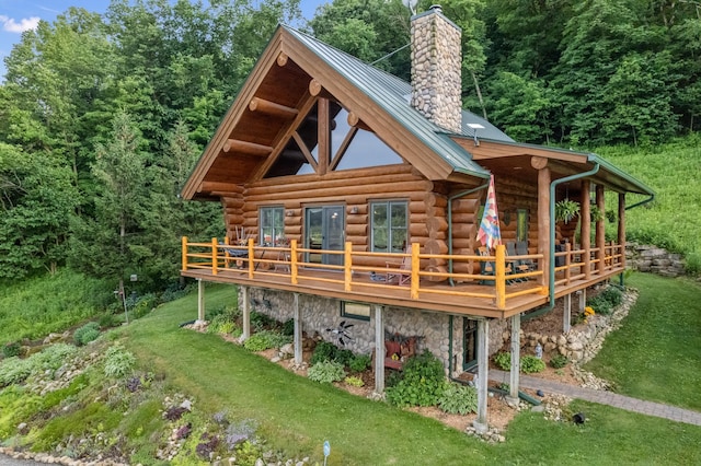30453 County Road 19, Wiscoy Twp, MN 55971 - back of house with a chimney, log exterior, a wooden deck, and a metal roof