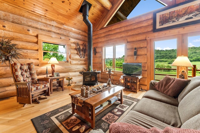 30453 County Road 19, Wiscoy Twp, MN 55971 - living area with a wood stove, wood finished floors, high vaulted ceiling, a wood ceiling with exposed beams, and log walls