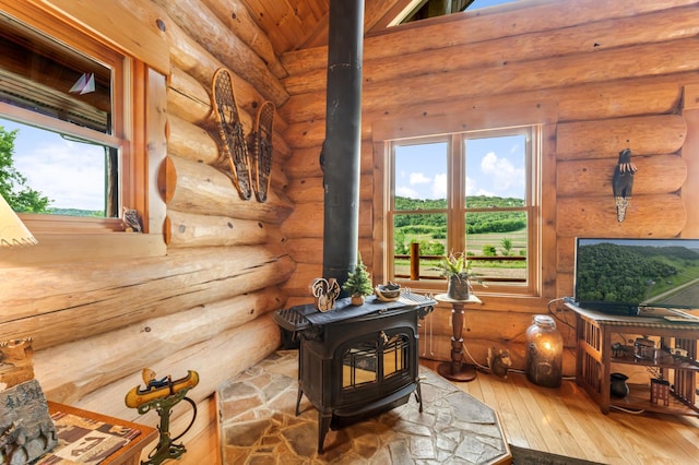 30453 County Road 19, Wiscoy Twp, MN 55971 - sitting room with a wood stove, hardwood / wood-style floors, and log walls