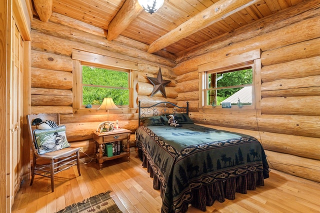 30453 County Road 19, Wiscoy Twp, MN 55971 - bedroom with a wood ceiling with exposed beams, wood-type flooring, and log walls