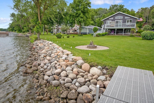 50945 Almond Ave, Nessel Twp, MN 55080 - view of grassy yard featuring an outdoor fire pit, a deck with water view, and stairway