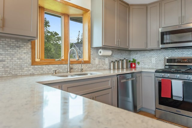 50945 Almond Ave, Nessel Twp, MN 55080 - kitchen with stainless steel appliances, gray cabinets, tasteful backsplash, and light stone counters