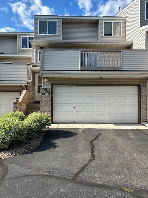 14509 Cobalt Ave Unit 2, Rosemount, MN 55068 - view of front of home with brick siding, an attached garage, and driveway