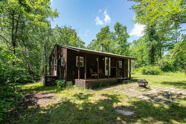 40936 Yost Rd, Emily, MN 56447 - rear view of property with a fire pit and a yard