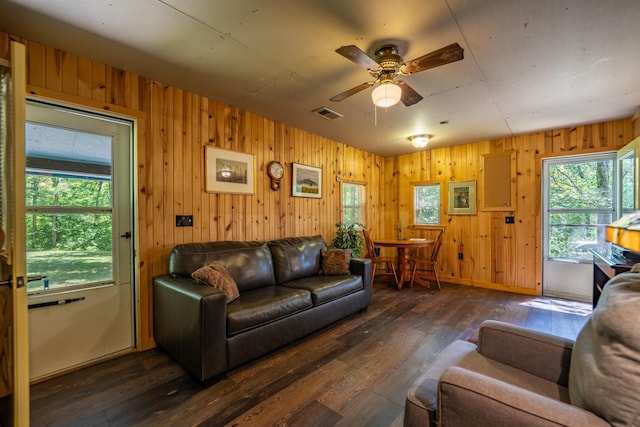 40936 Yost Rd, Emily, MN 56447 - living area featuring a ceiling fan, dark wood-type flooring, and wooden walls