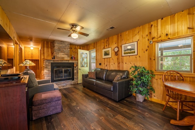 40936 Yost Rd, Emily, MN 56447 - living room with wooden walls, ceiling fan, wood-type flooring, and a fireplace