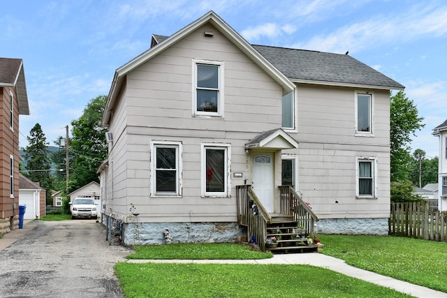 159 King St, Winona, MN 55987 - view of front of home featuring an outdoor structure, roof with shingles, and a detached garage
