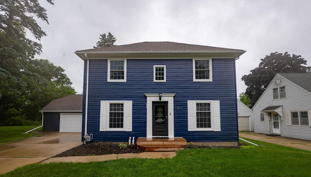 1304 3rd St NW, Austin, MN 55912 - colonial inspired home with a detached garage, a front yard, an outbuilding, and driveway