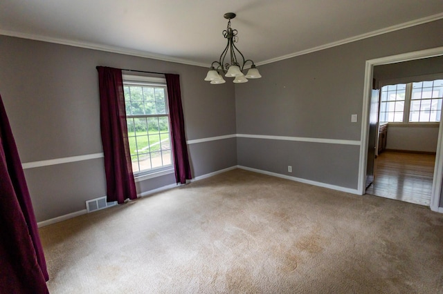 1304 3rd St NW, Austin, MN 55912 - spare room with a chandelier, ornamental molding, plenty of natural light, and carpet flooring
