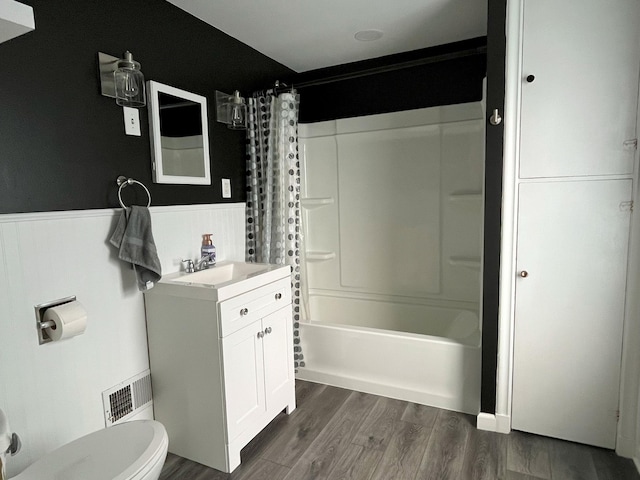 1304 3rd St NW, Austin, MN 55912 - full bathroom featuring a wainscoted wall, vanity, shower / tub combo, and wood finished floors