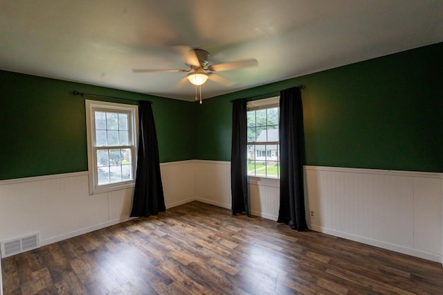 1304 3rd St NW, Austin, MN 55912 - empty room with a wainscoted wall, a ceiling fan, and wood finished floors