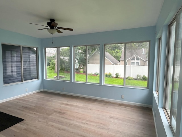 1304 3rd St NW, Austin, MN 55912 - unfurnished sunroom featuring wood finished floors and baseboards