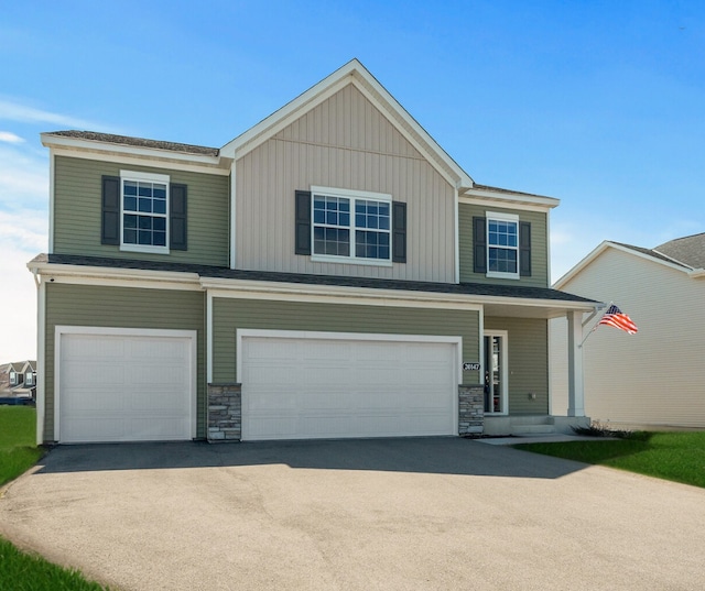 20147 79th Ave, Corcoran, MN 55340 - view of front of home featuring an attached garage, driveway, and stone siding
