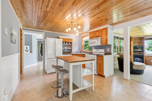 26952 Alpha Ln, Center Twp, MN 56465 - kitchen with white appliances, butcher block counters, wood ceiling, healthy amount of natural light, and light tile patterned floors