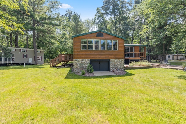 26952 Alpha Ln, Center Twp, MN 56465 - rear view of property featuring a deck, a yard, stone siding, view of wooded area, and faux log siding