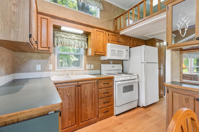 26952 Alpha Ln, Center Twp, MN 56465 - kitchen with white appliances, brown cabinets, light wood-style flooring, ornamental molding, and a high ceiling