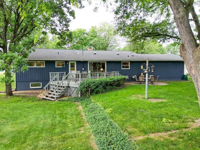 715 River Heights Rd SW, Menomonie, WI 54751 - rear view of property with a wooden deck, a lawn, a chimney, and roof with shingles