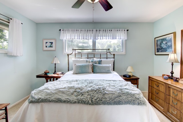 715 River Heights Rd SW, Menomonie, WI 54751 - bedroom with light colored carpet, multiple windows, and a ceiling fan