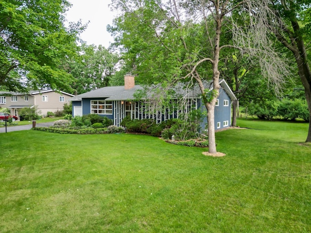 715 River Heights Rd SW, Menomonie, WI 54751 - view of front of property featuring a chimney, a front lawn, and roof with shingles