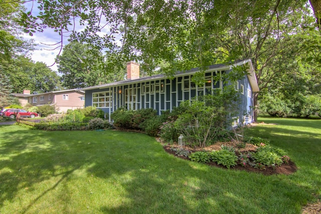715 River Heights Rd SW, Menomonie, WI 54751 - back of house featuring a chimney and a lawn