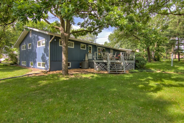 715 River Heights Rd SW, Menomonie, WI 54751 - back of house featuring a wooden deck, a yard, and board and batten siding