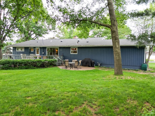 715 River Heights Rd SW, Menomonie, WI 54751 - back of house with a wooden deck, a lawn, a patio, and board and batten siding