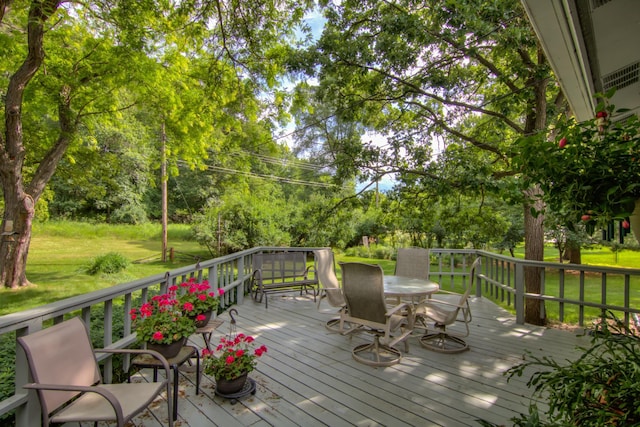 715 River Heights Rd SW, Menomonie, WI 54751 - deck featuring a yard, outdoor dining space, and view of wooded area