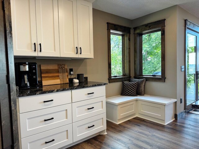 8766 Interlachen Rd, Lake Shore, MN 56468 - kitchen featuring white cabinetry, dark wood finished floors, and dark stone countertops