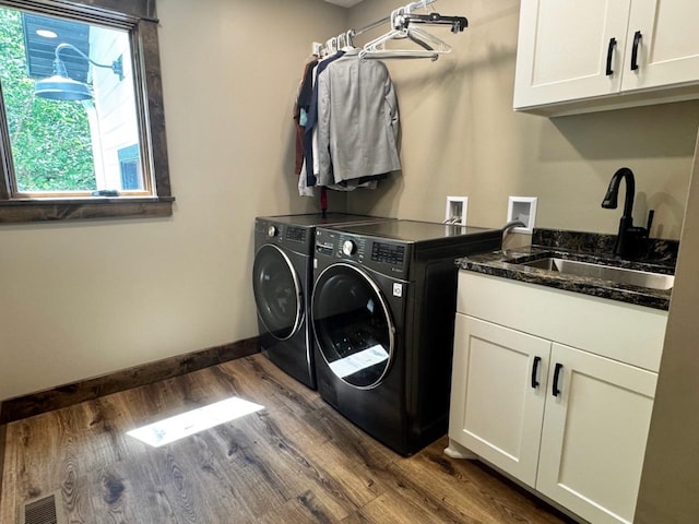 8766 Interlachen Rd, Lake Shore, MN 56468 - laundry room featuring washing machine and clothes dryer, dark wood finished floors, and cabinet space