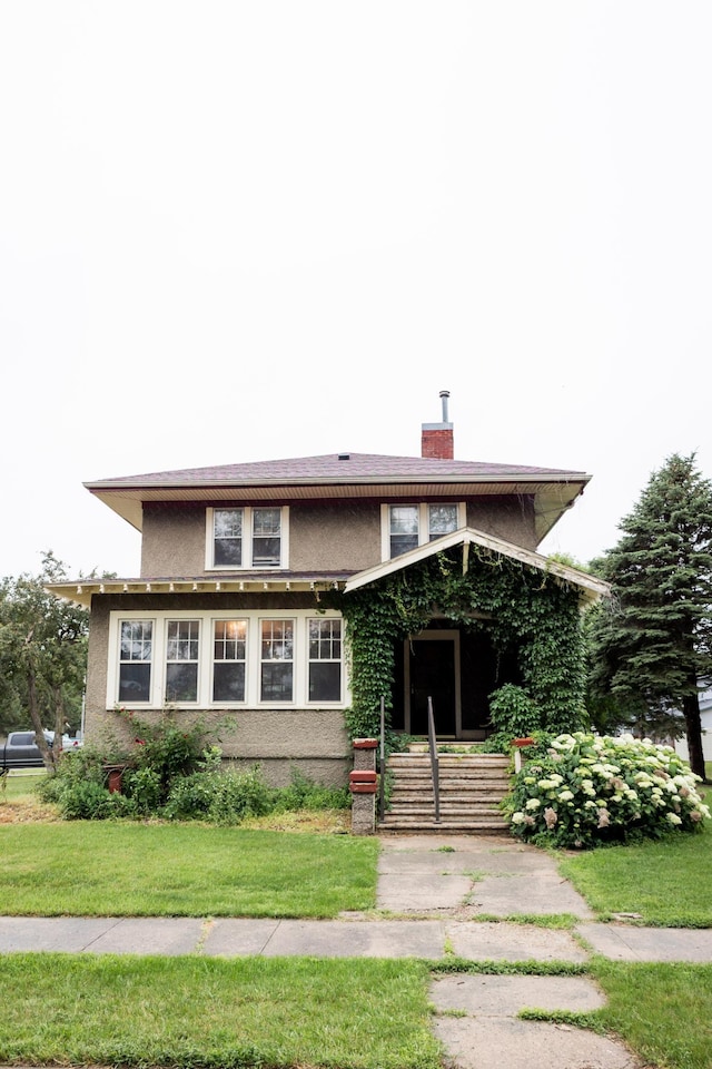 605 Chestnut St, Ellsworth, MN 56129 - view of front of property with stucco siding, a chimney, and a front yard
