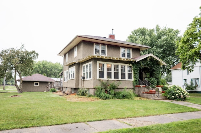 605 Chestnut St, Ellsworth, MN 56129 - view of front facade with a chimney, stucco siding, and a front yard