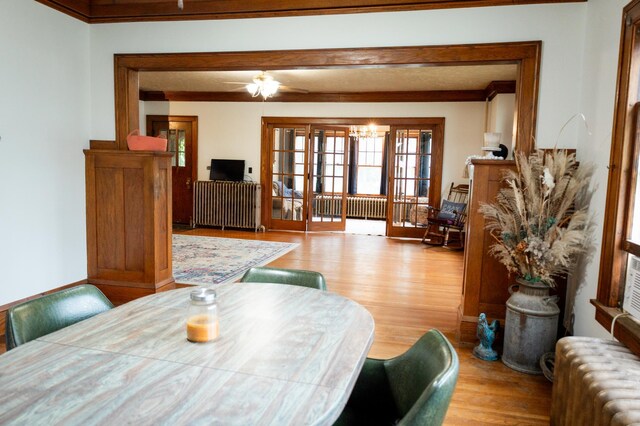 605 Chestnut St, Ellsworth, MN 56129 - dining room with radiator heating unit, wood finished floors, ornamental molding, and a chandelier