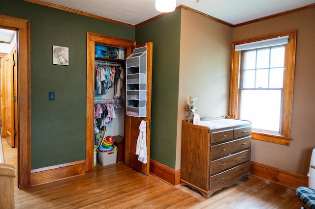 605 Chestnut St, Ellsworth, MN 56129 - bedroom featuring crown molding, light wood finished floors, and a closet
