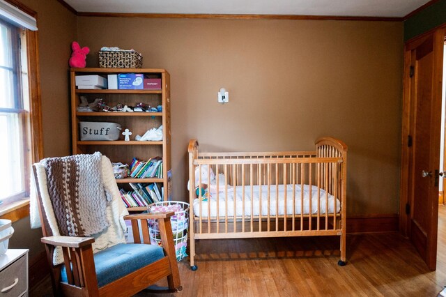 605 Chestnut St, Ellsworth, MN 56129 - bedroom with wood finished floors and crown molding
