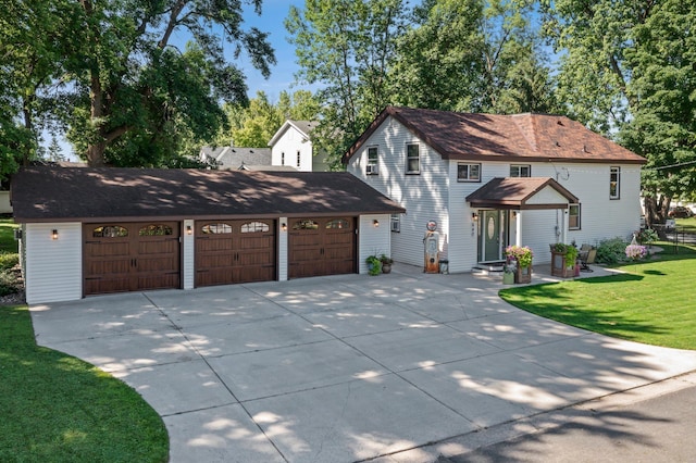 640 3rd St N, Dassel, MN 55325 - view of front of house featuring concrete driveway, a front lawn, and an attached garage