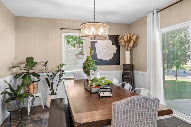 640 3rd St N, Dassel, MN 55325 - dining room featuring dark stone finish floors, a chandelier, and a wainscoted wall