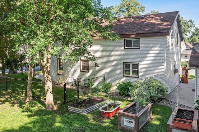 640 3rd St N, Dassel, MN 55325 - view of side of property featuring a garden and a shingled roof